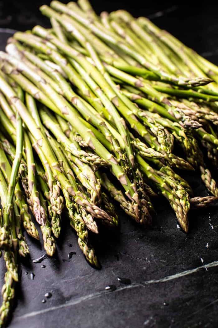 No Stir Brie Risotto with Lemon Butter Asparagus | halfbakedharvest.com prep photo of raw Asparagus