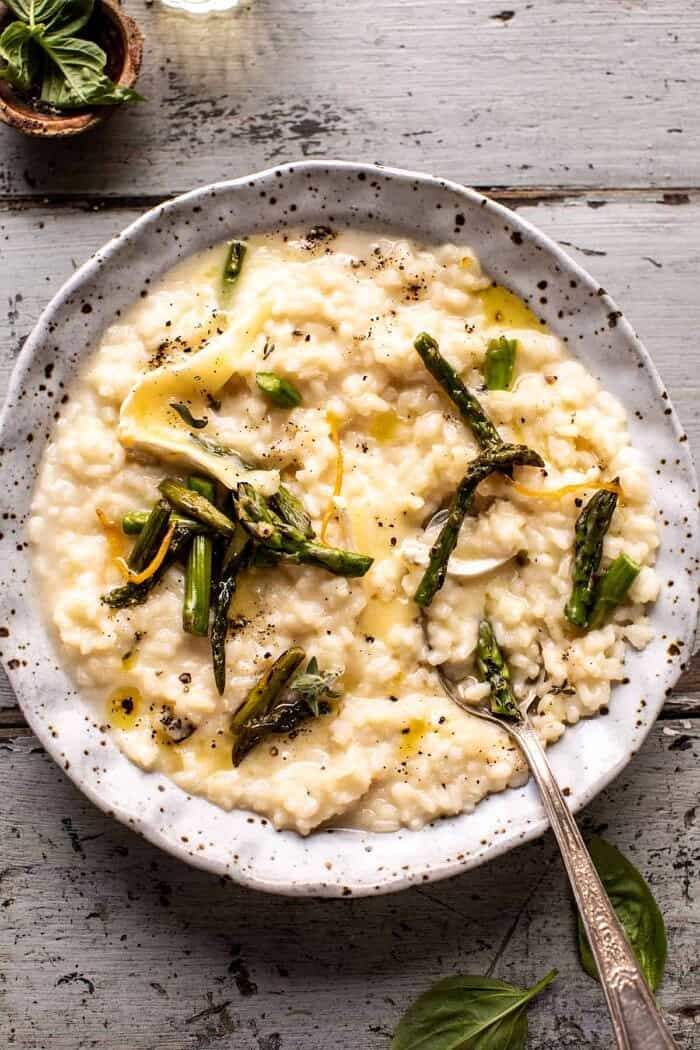 No Stir Brie Risotto with Lemon Butter Asparagus | halfbakedharvest.com overhead photo of No Stir Brie Risotto with Lemon Butter Asparagus with spoon in bowl