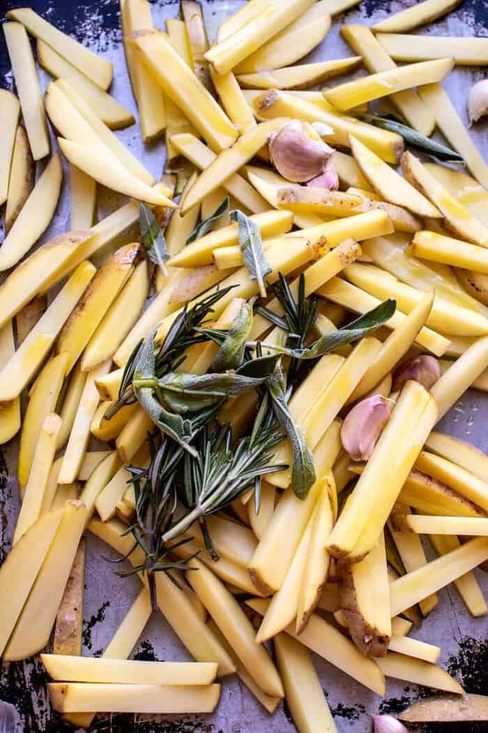 Oven Baked Tuscan Fries | halfbakedharvest.com Tuscan Fries on baking sheet before baking