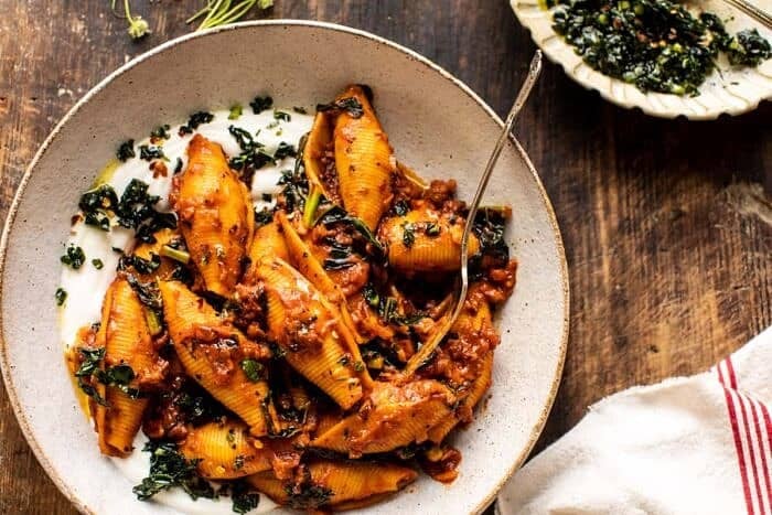 overhead close up photo of Unstuffed Spicy Tomato Basil Shells with Whipped Ricotta