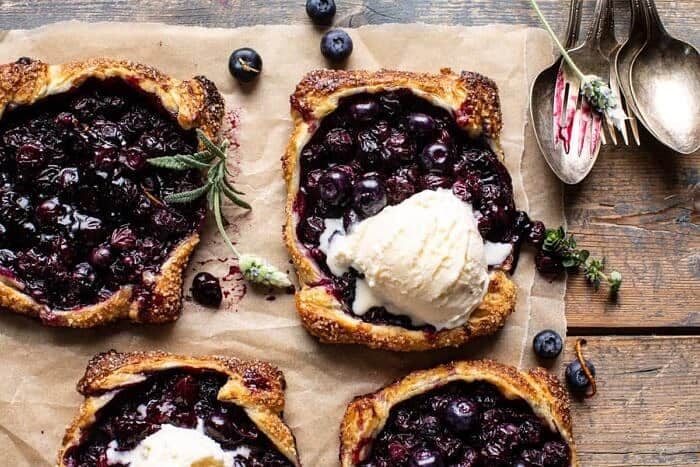 Bursting Blueberry Lemon Thyme Tarts | halfbakedharvest.com overhead horizontal photo of Bursting Blueberry Lemon Thyme Tarts