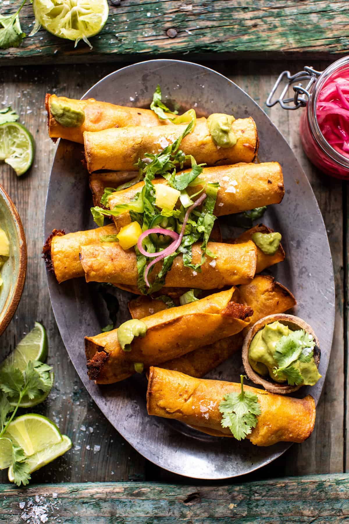 Crispy Chicken Tinga Taquitos with Salty Lime Avocado Crema | halfbakedharvest.com