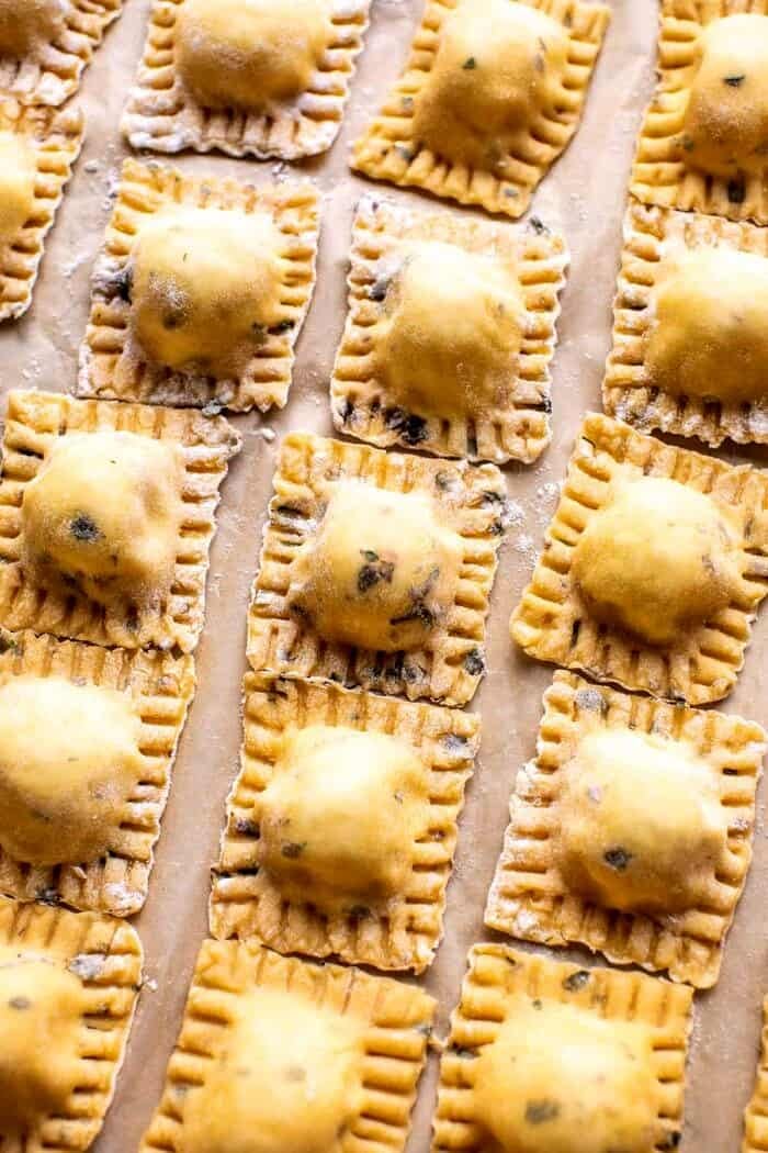 prep photo of raw Cheese Ravioli on parchment paper before cooking 