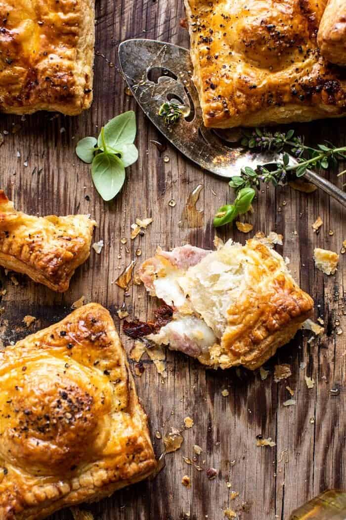 overhead photo of Prosciutto Caprese Puff Pastry torn in half to expose the filling inside 