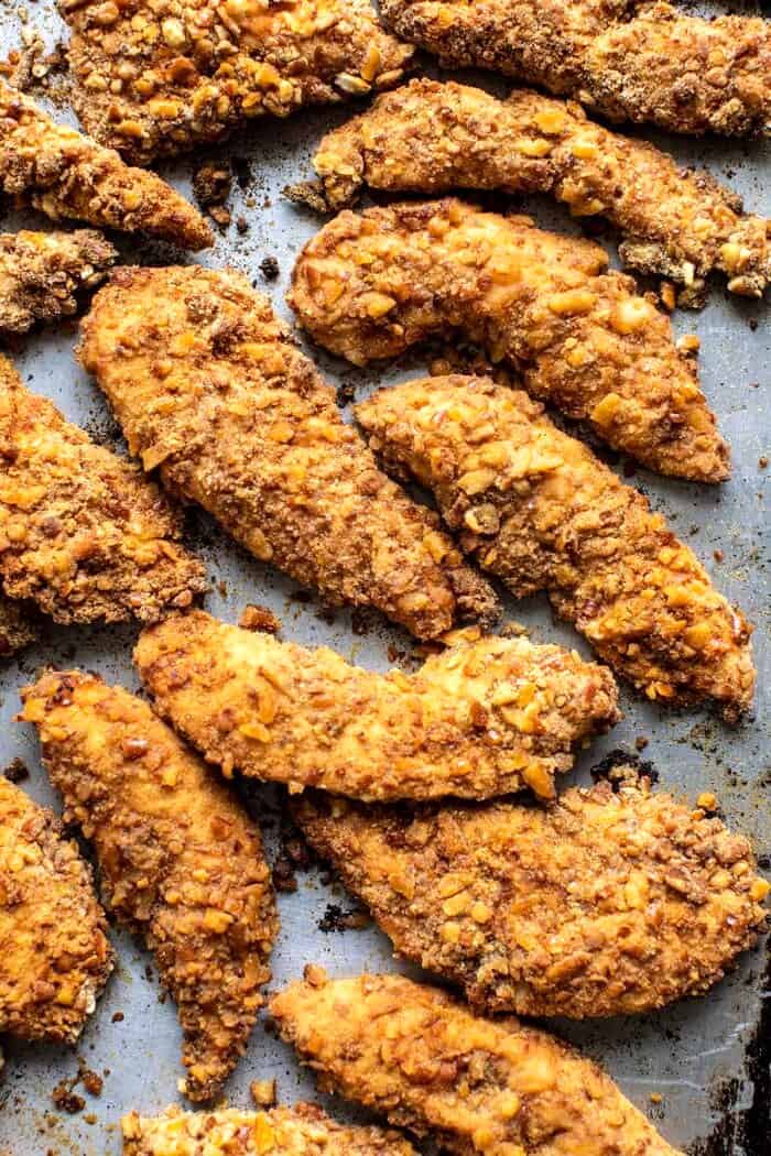 Spicy Honey Mustard Pretzel Chicken Fingers | halfbakedharvest.com overhead prep photo of Spicy Honey Mustard Pretzel Chicken Fingers sitting on baking sheet after baking