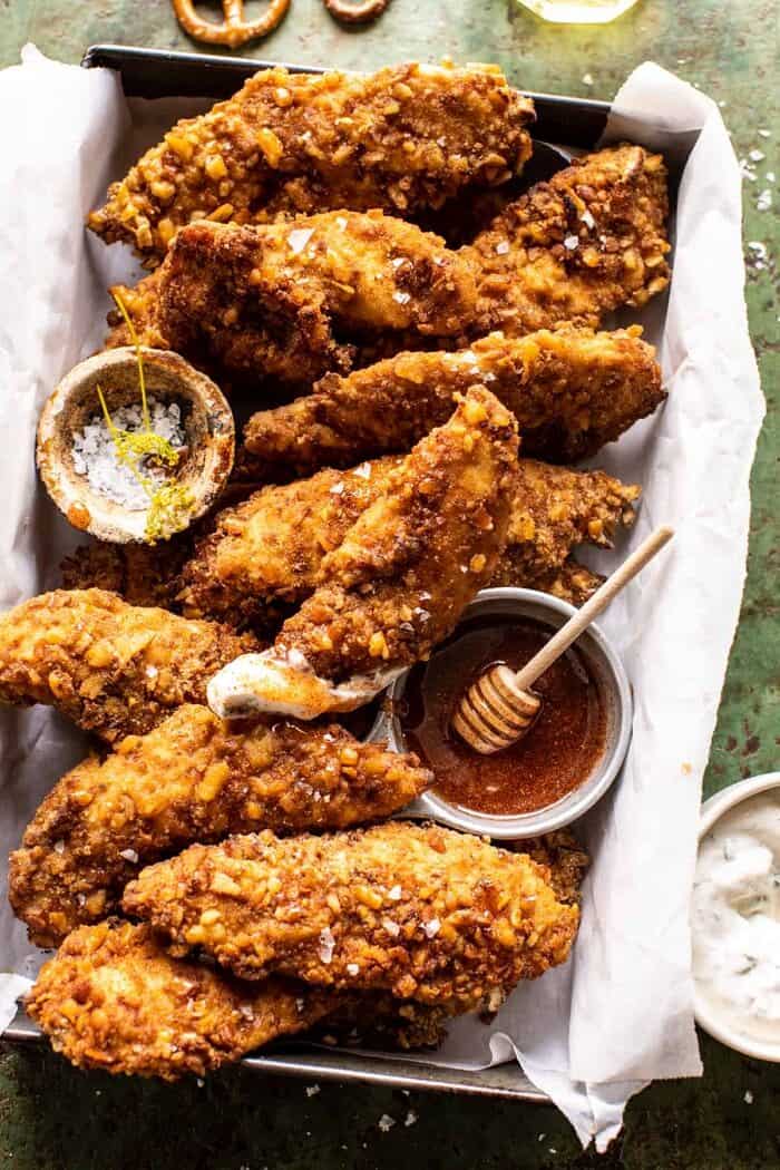 Spicy Honey Mustard Pretzel Chicken Fingers | halfbakedharvest.com overhead photo of Spicy Honey Mustard Pretzel Chicken Fingers with sauce on chicken fingers