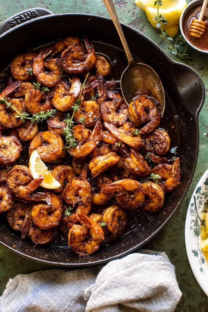 overhead photo of 15 Minute Cajun Hot Honey Butter Shrimp in skillet with spoon