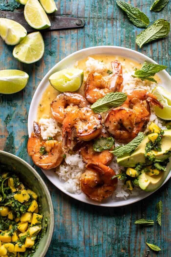 overhead photo of 20 Minute Honey Garlic Butter Shrimp on plate with rice and mangos 