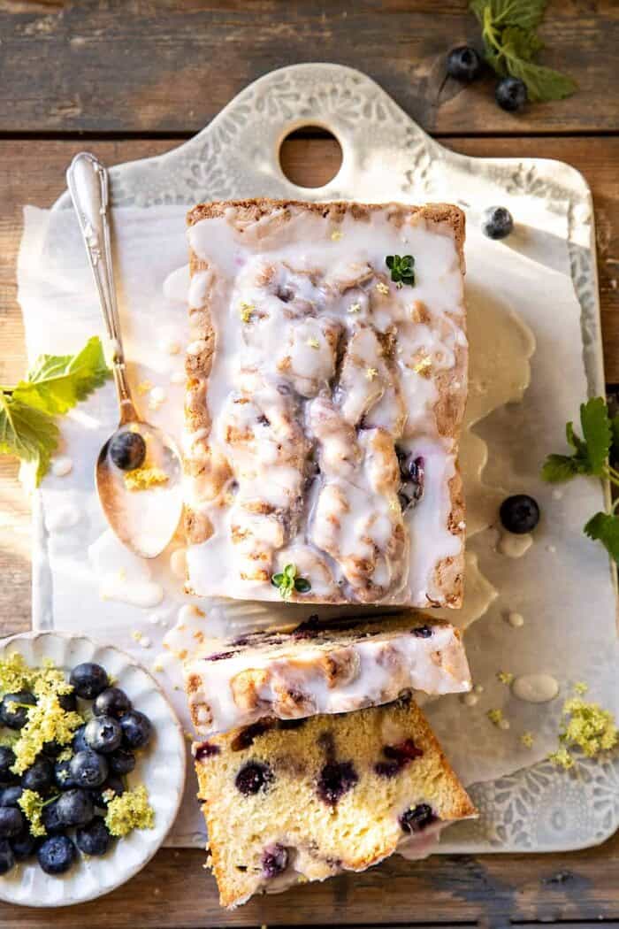 overhead photo of Blueberry Lemon Thyme Cake with 2 slices cut