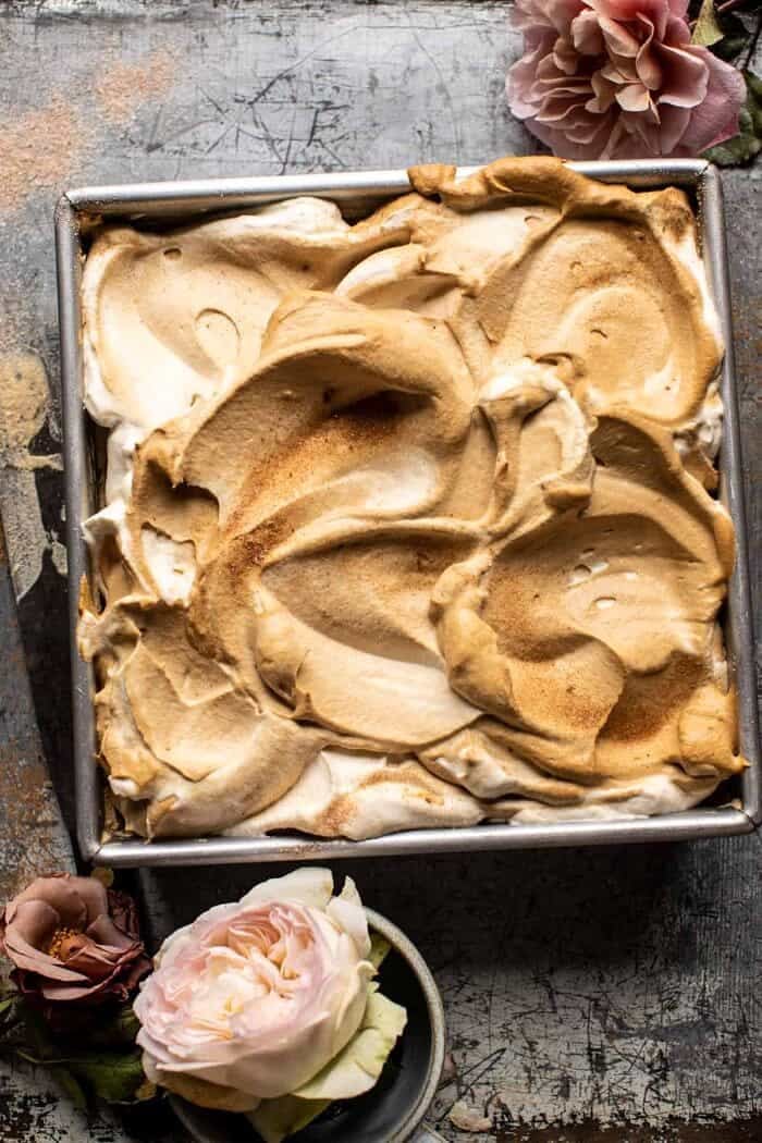 overhead photo of Dirty Horchata Tres Leches Cake in pan with whipped cream