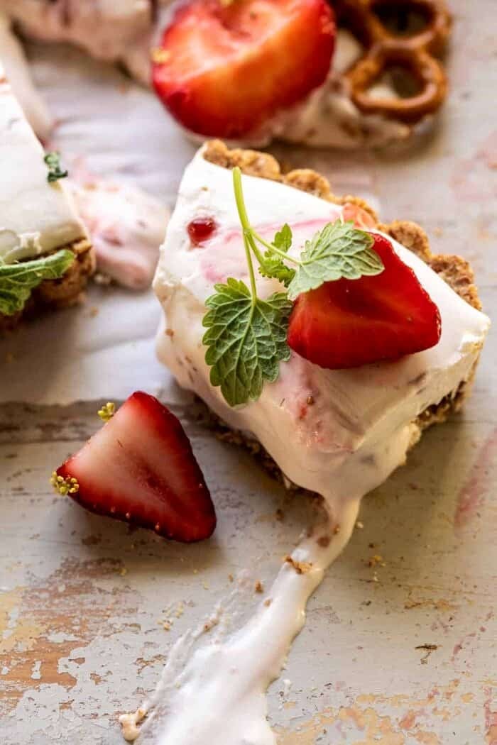 Double Strawberry Pretzel Pie | halfbakedharvest.com overhead photo of Double Strawberry Pretzel Pie slice with bite taken out of slice