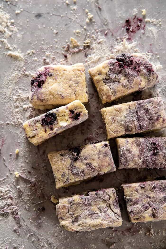 oveherad photo of Blackberry Lavender White Chocolate Scone dough on counter after cutting into squares