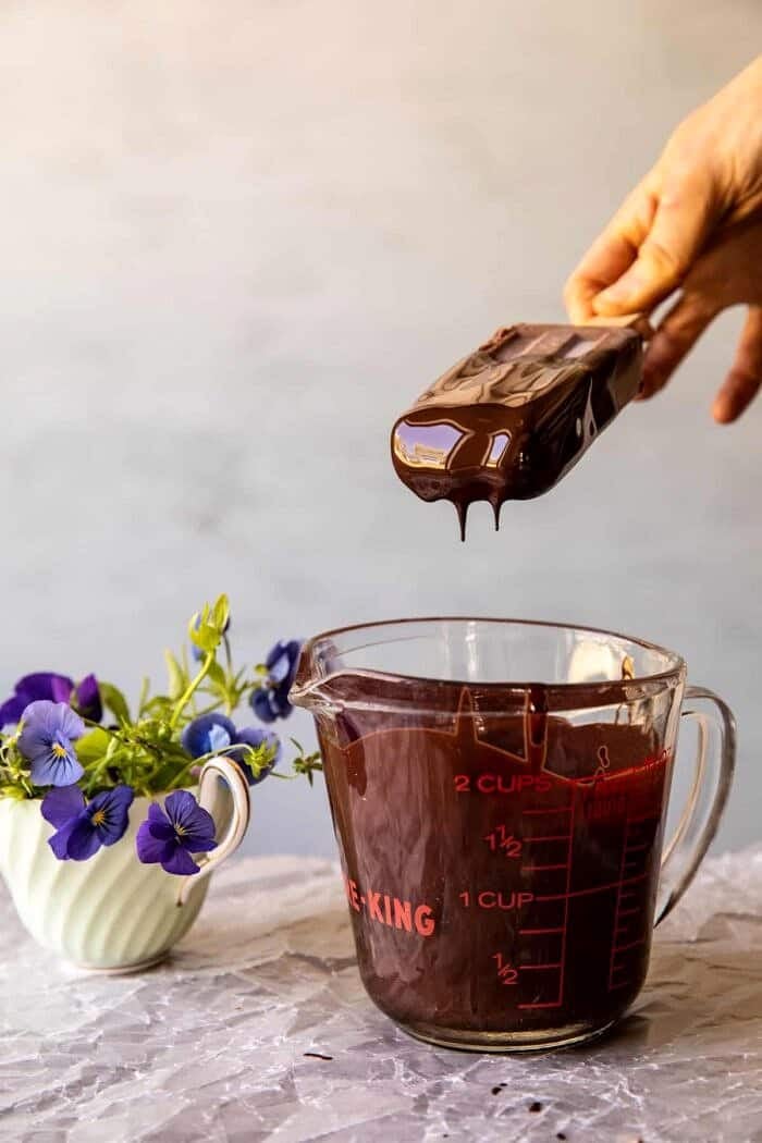 action photo of Creamy Vegan Chocolate Fudge Pops being dipped in chocolate