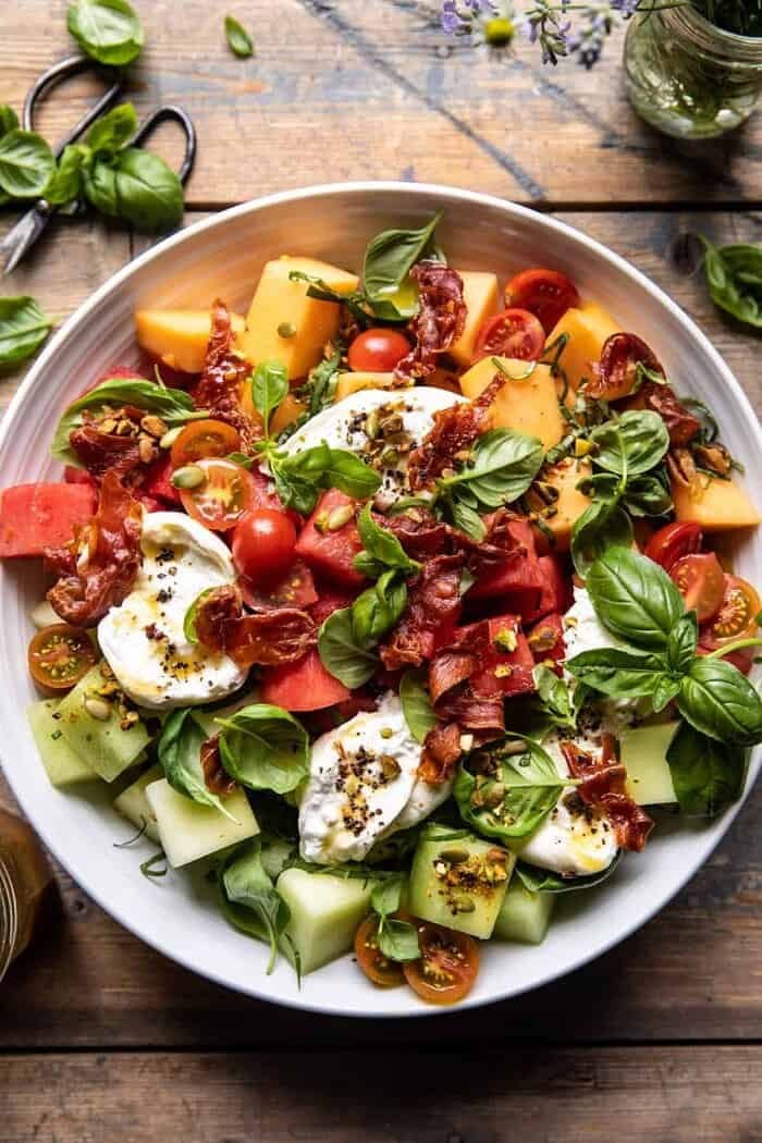 overhead close up photo of Melon Basil Burrata Salad with Crispy Prosciutto