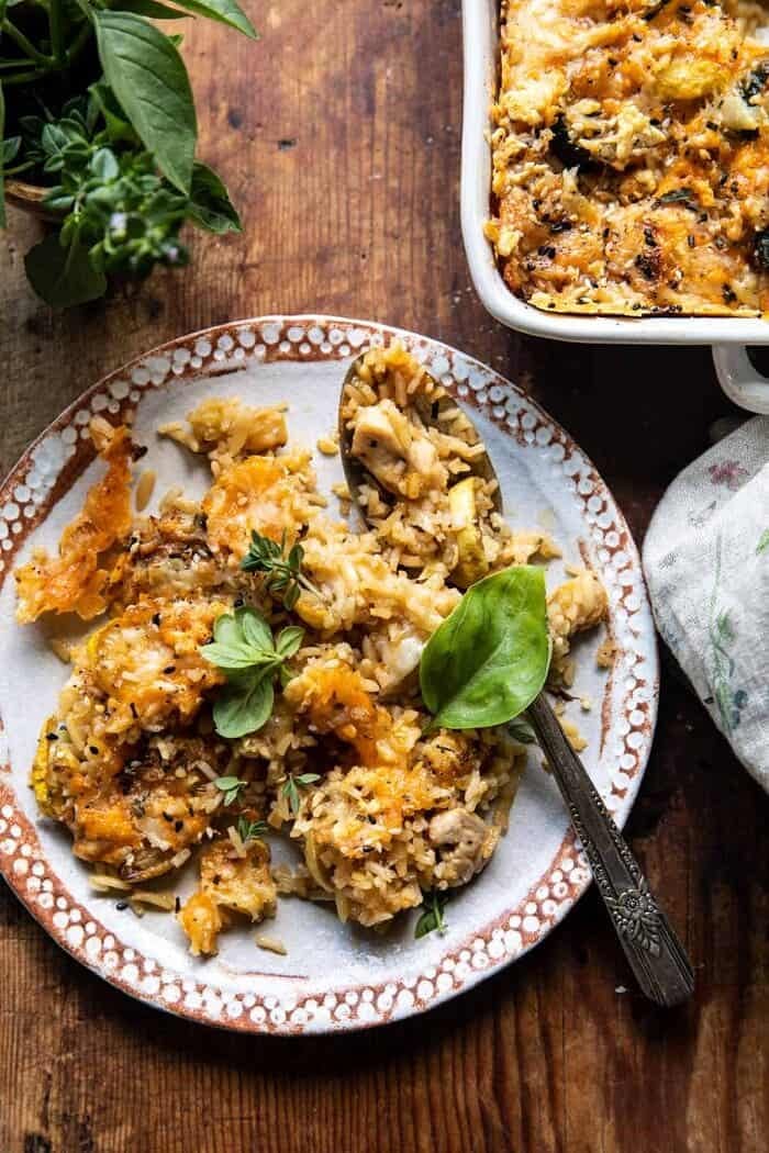 overhead photo of Cheesy Zucchini Chicken and Rice Bake on plate with spoon