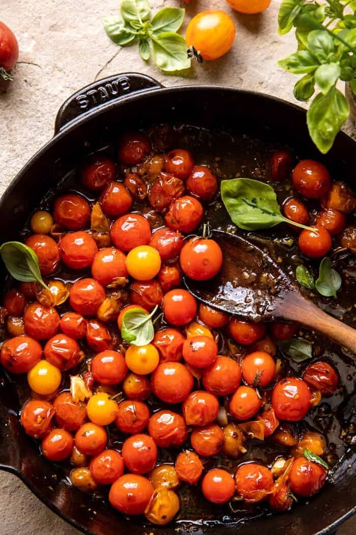 Cherry Tomato Pesto Polenta with Fried Halloumi | halfbakedharvest.com overhead photo of Cherry Tomatoes in skillet
