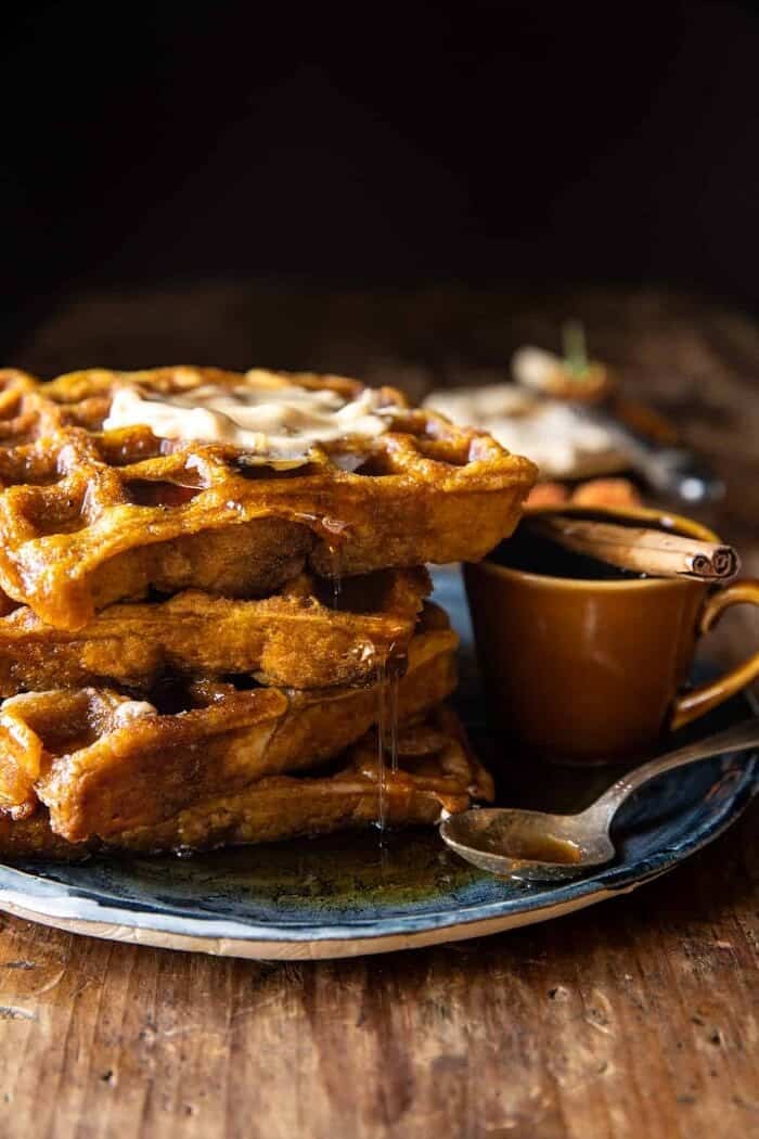 Cider Pumpkin Waffles with Salted Maple Butter | halfbakedharvest.com side angled photo of Cider Pumpkin Waffles with Salted Maple Butter