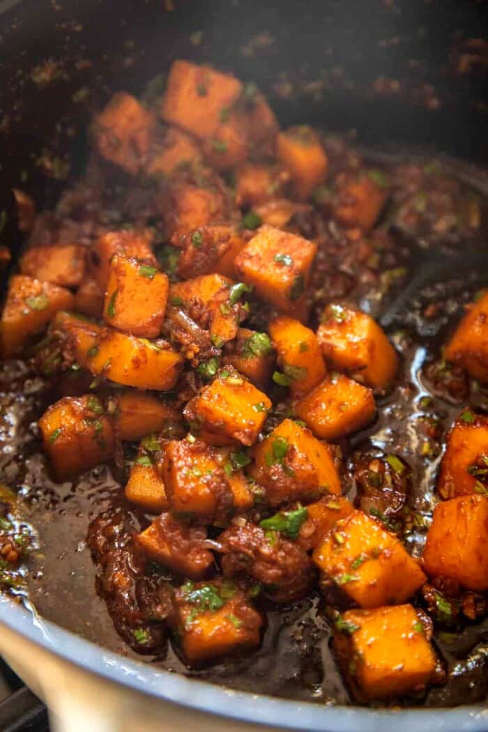 Creamy Coconut Chicken Meatball and Noodle Curry | halfbakedharvest.com side angled prep photo of cooking in soup pot
