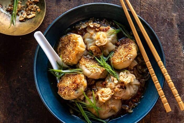 Sesame Chicken Dumplings in Spicy Broth with Garlic Crisps | halfbakedharvest.com overhead horizontal photo of Sesame Chicken Dumplings in Spicy Broth with Garlic Crisps