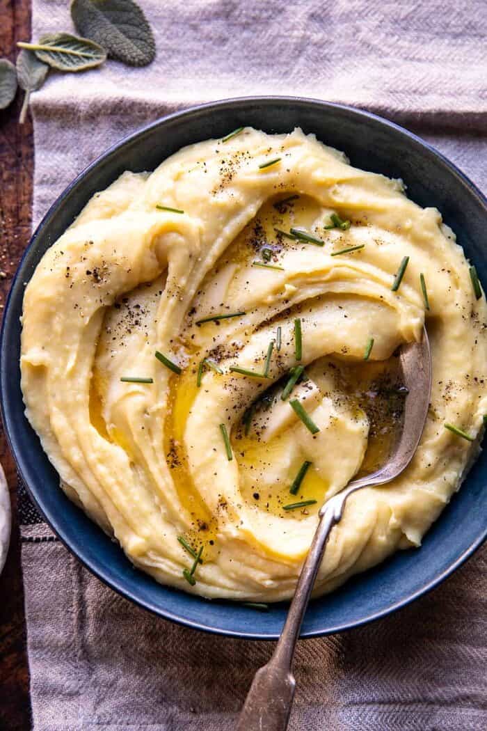 Slow Cooker Cheesy Garlic Herb Mashed Potatoes | halfbakedharvest.com overhead photo of Slow Cooker Cheesy Garlic Herb Mashed Potatoes in serving bowl