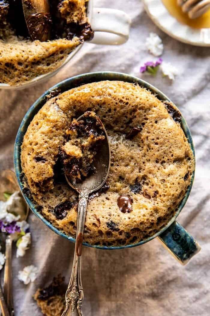 5 Minute Chocolate Chunk Banana Bread Mug Cake | halfbakedharvest.com overhead close up photo of 5 Minute Chocolate Chunk Banana Bread Mug Cake