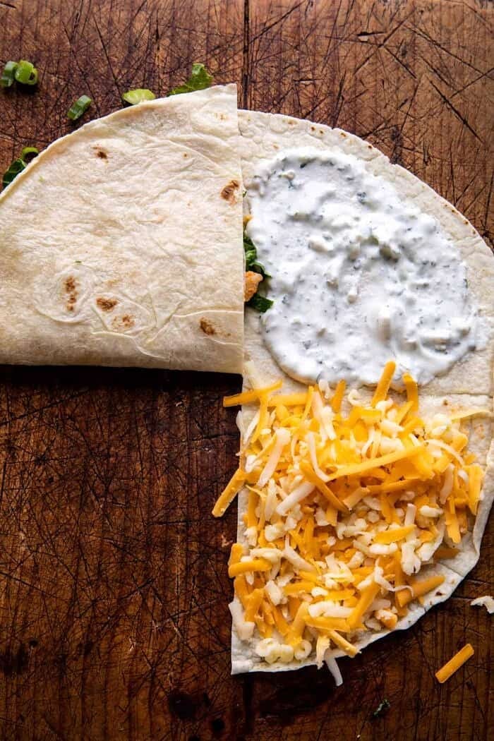 Folded Crispy Buffalo Chicken Wraps | halfbakedharvest.com prep photo of folding the wraps