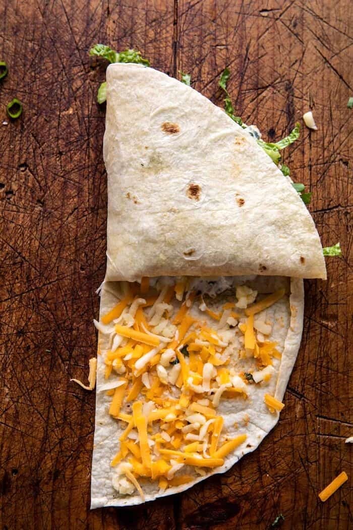 Folded Crispy Buffalo Chicken Wraps | halfbakedharvest.com prep photo of folding the wraps