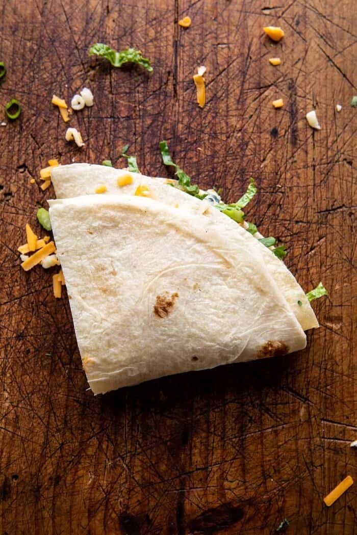 Folded Crispy Buffalo Chicken Wraps | halfbakedharvest.com prep photo of folding the wraps