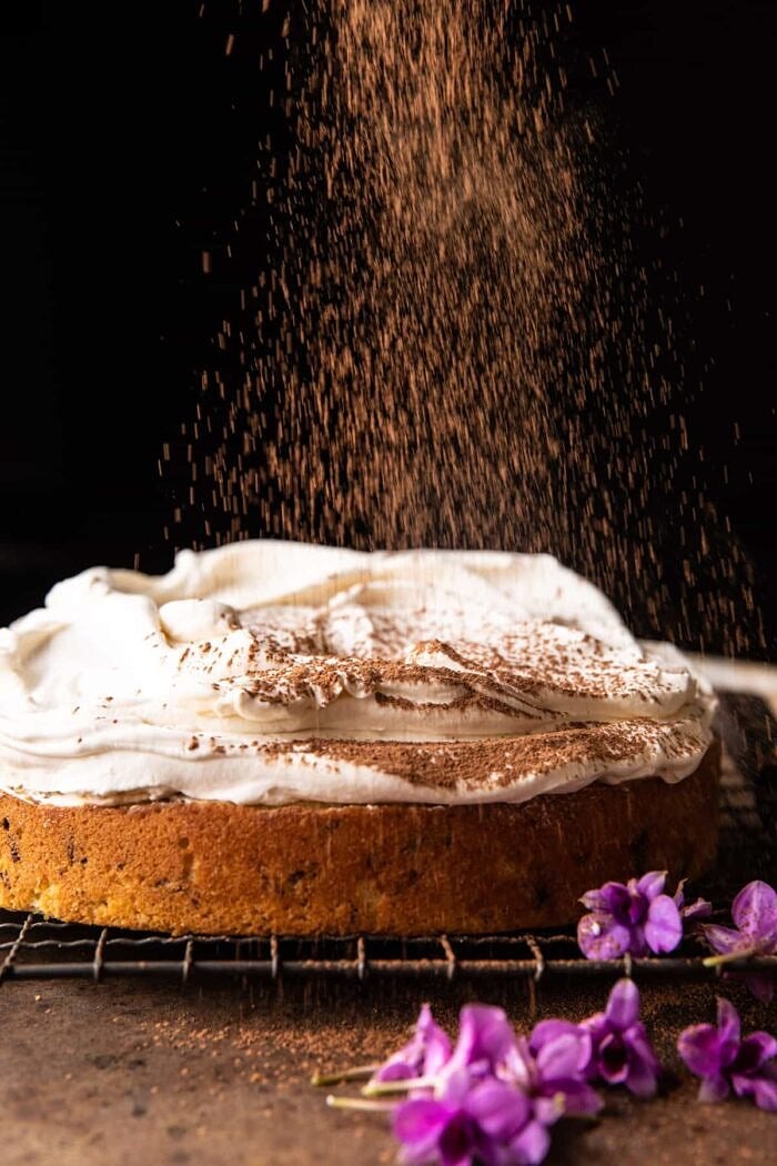 Vanilla Tiramisu Cake | halfbakedharvest.com process photo of Vanilla Tiramisu Cake being dusted with cocoa