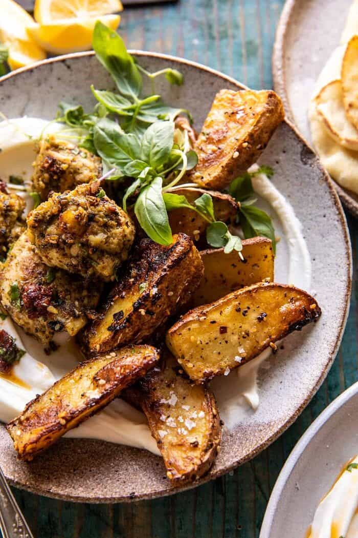 side angled photo of Sheet Pan Pesto Chicken and Lemon Butter Potatoes with Whipped Feta 