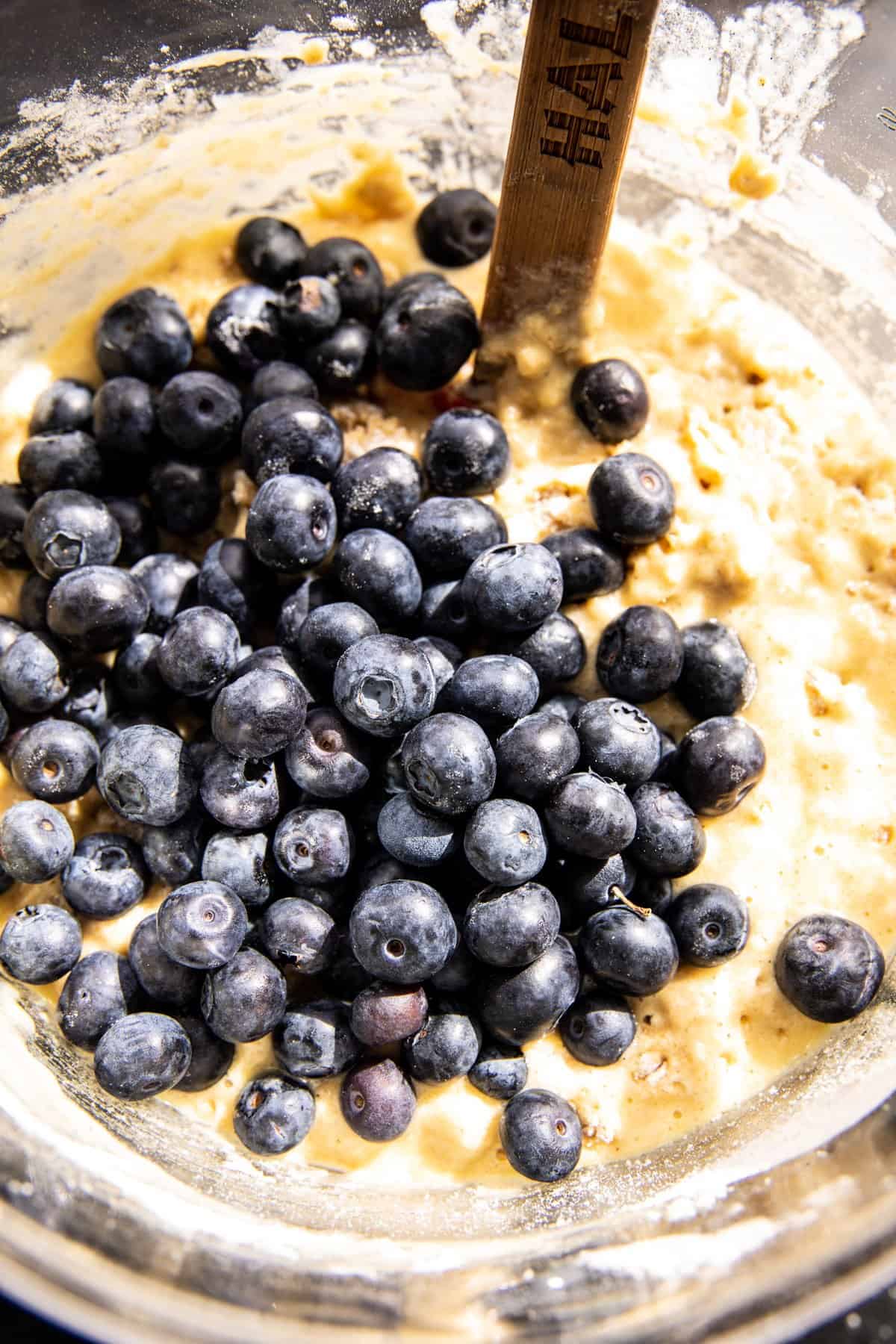 blueberries being added to the batter 