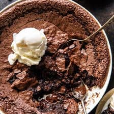 photo of pudding with ice cream on top and spoons in pudding