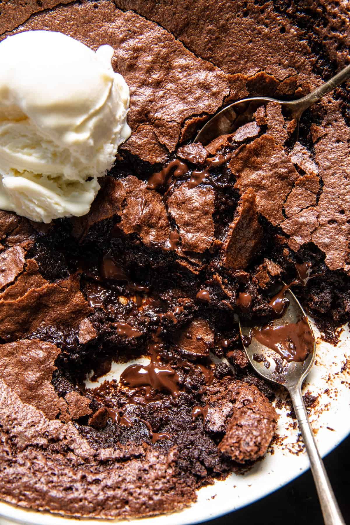 close up photo of pudding with ice cream and spoons 