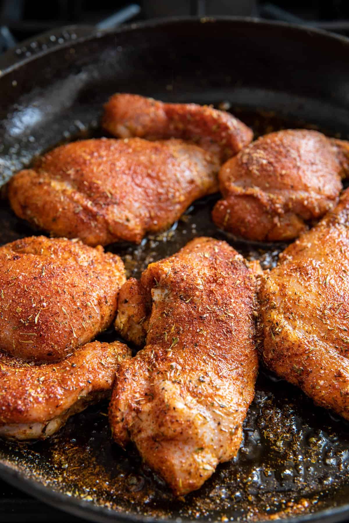 raw chicken cooking in skillet 